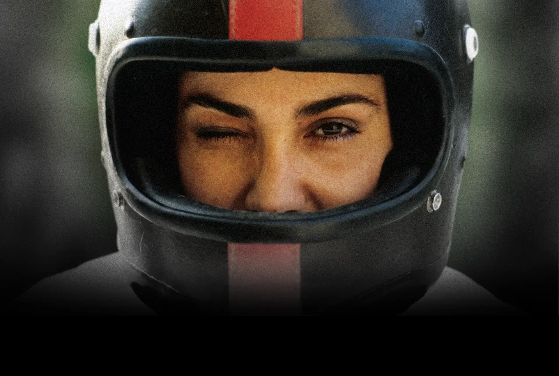 A woman in a helmet winking